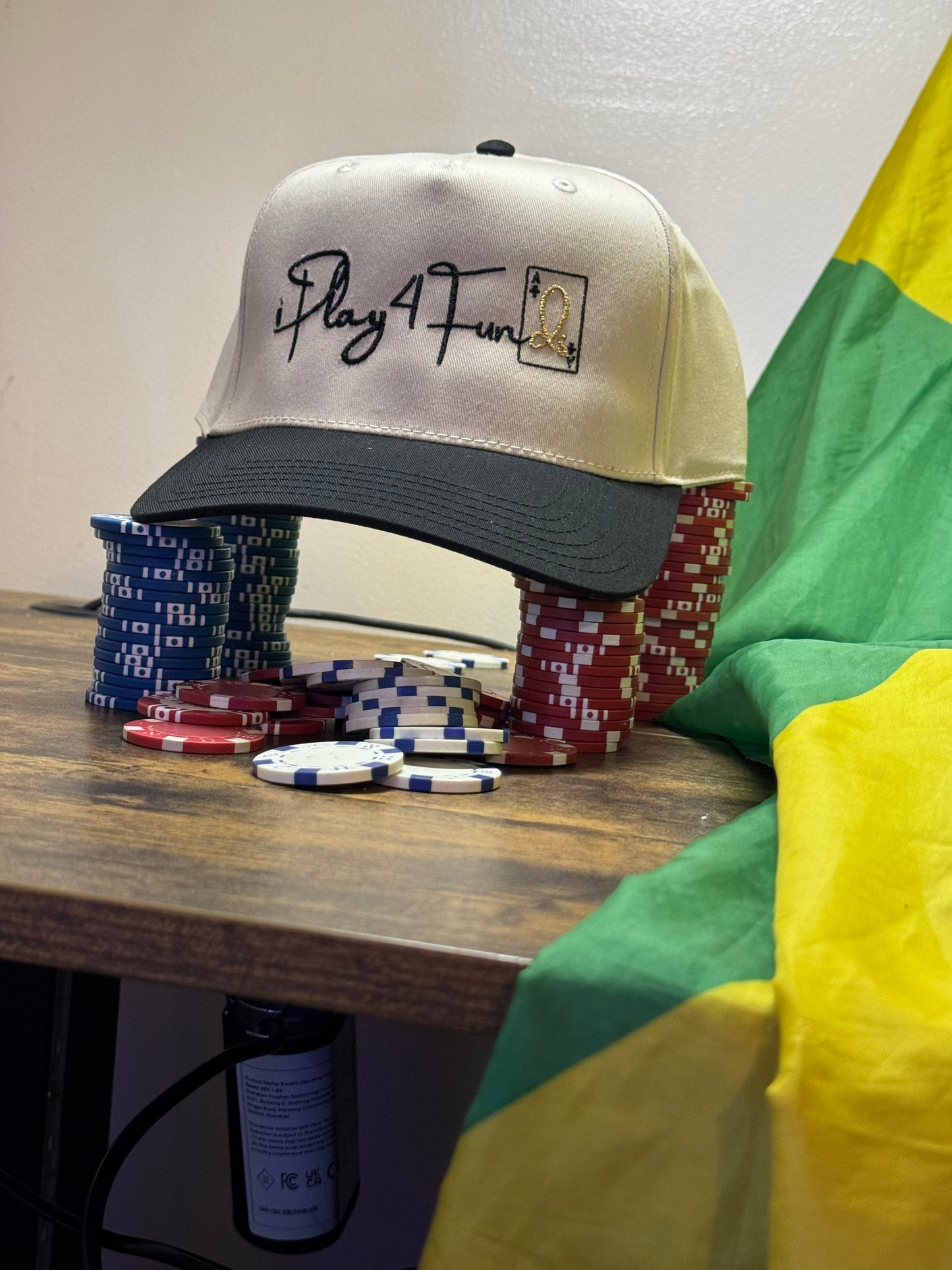 Black snapback hat featuring ‘iPlay4Funds’ embroidered on the front, structured design, and adjustable closure. Ideal poker apparel