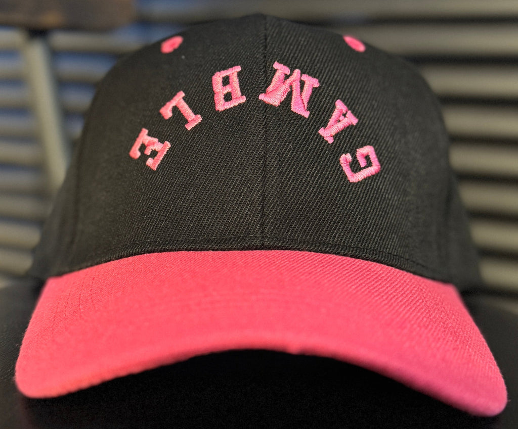 pink poker hat with bold embroidered logo, featuring a sleek design perfect for any poker enthusiast. Ideal poker clothing for players looking to make a statement both on and off the tables.