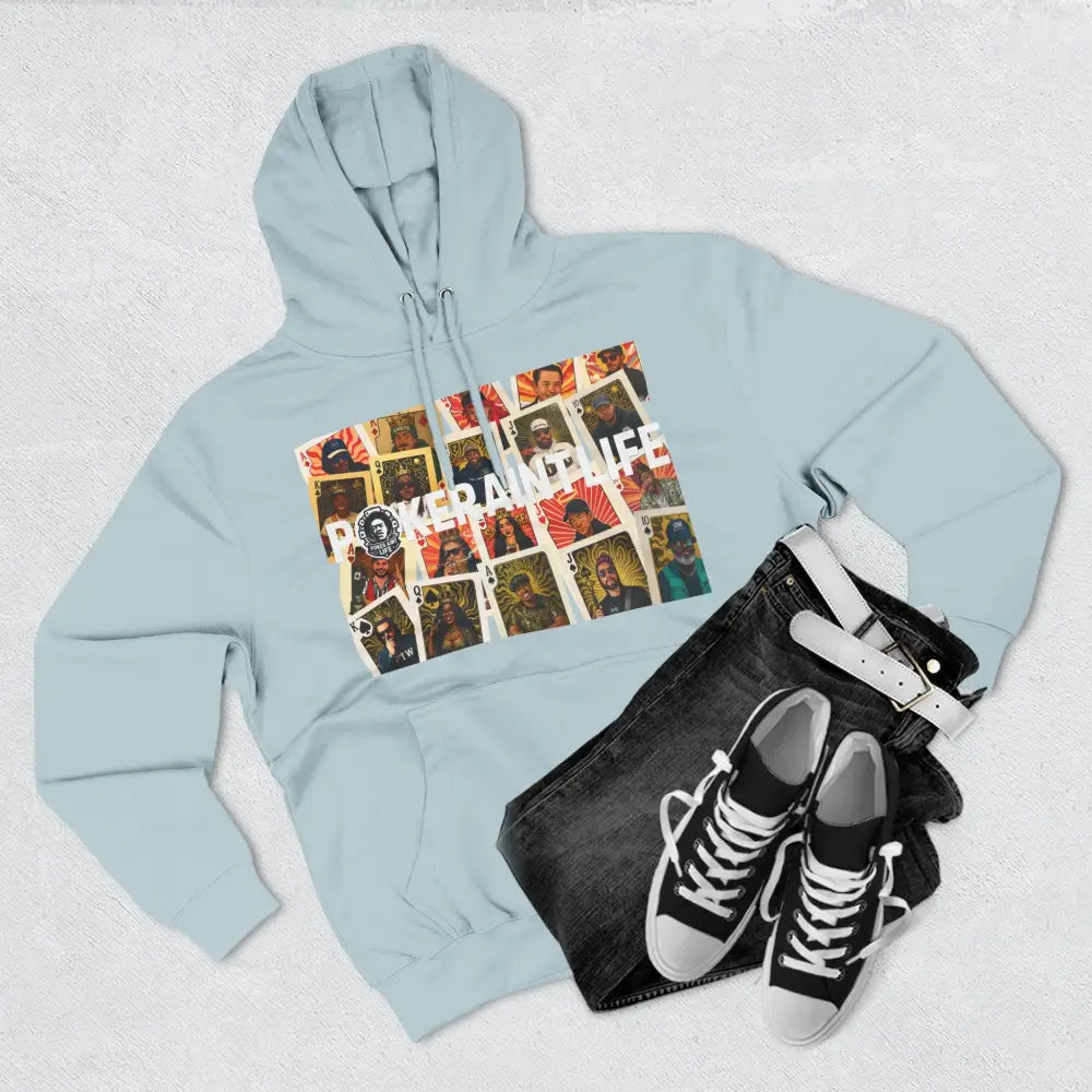 Light blue hoodie with graphic design, black jeans, and black sneakers on a light gray background