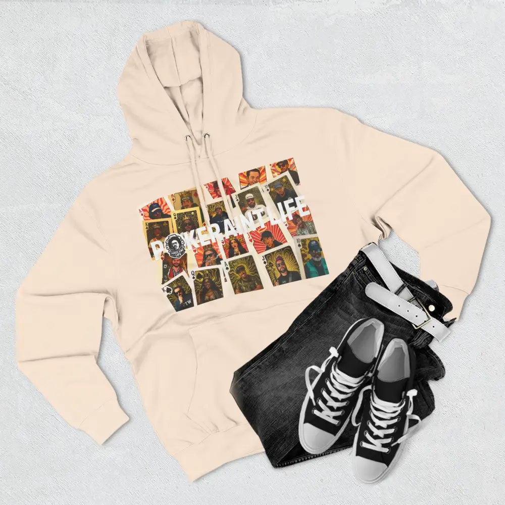 Beige hoodie with graphic design, black jeans, and black sneakers on a light gray background