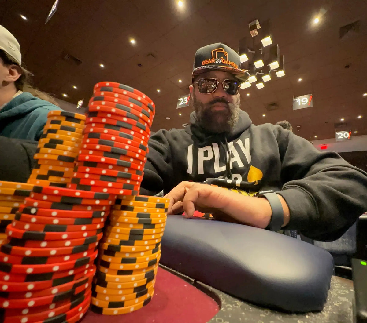 Stacks of red and orange poker chips with black stripes and white dots.