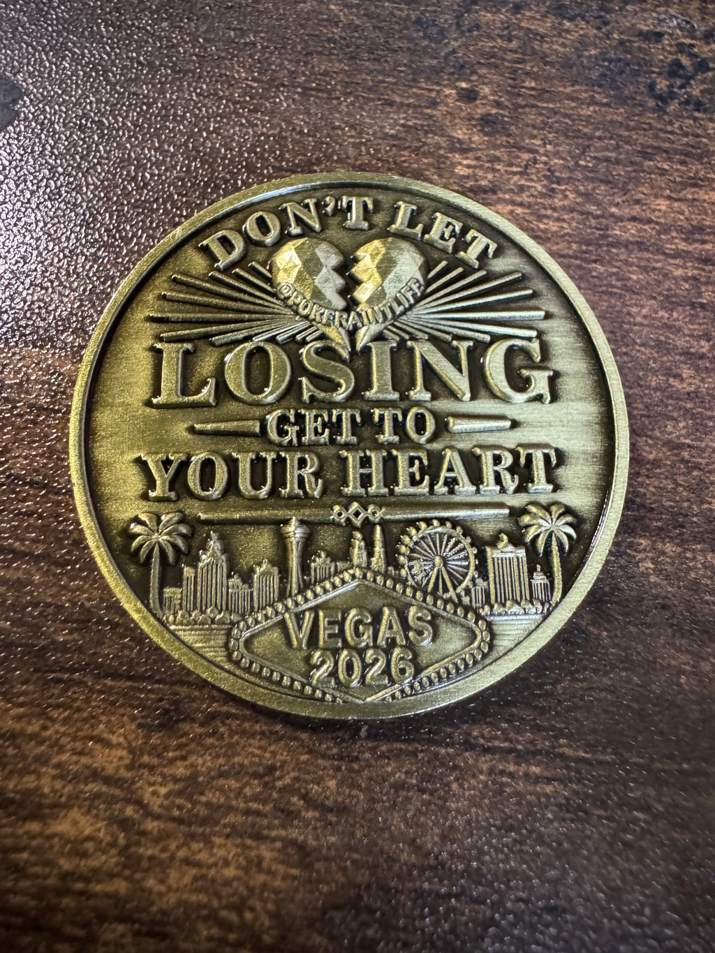gold card protector coing that says dont let winning go to your head on one side and dont let losing go to your heart on the other side.