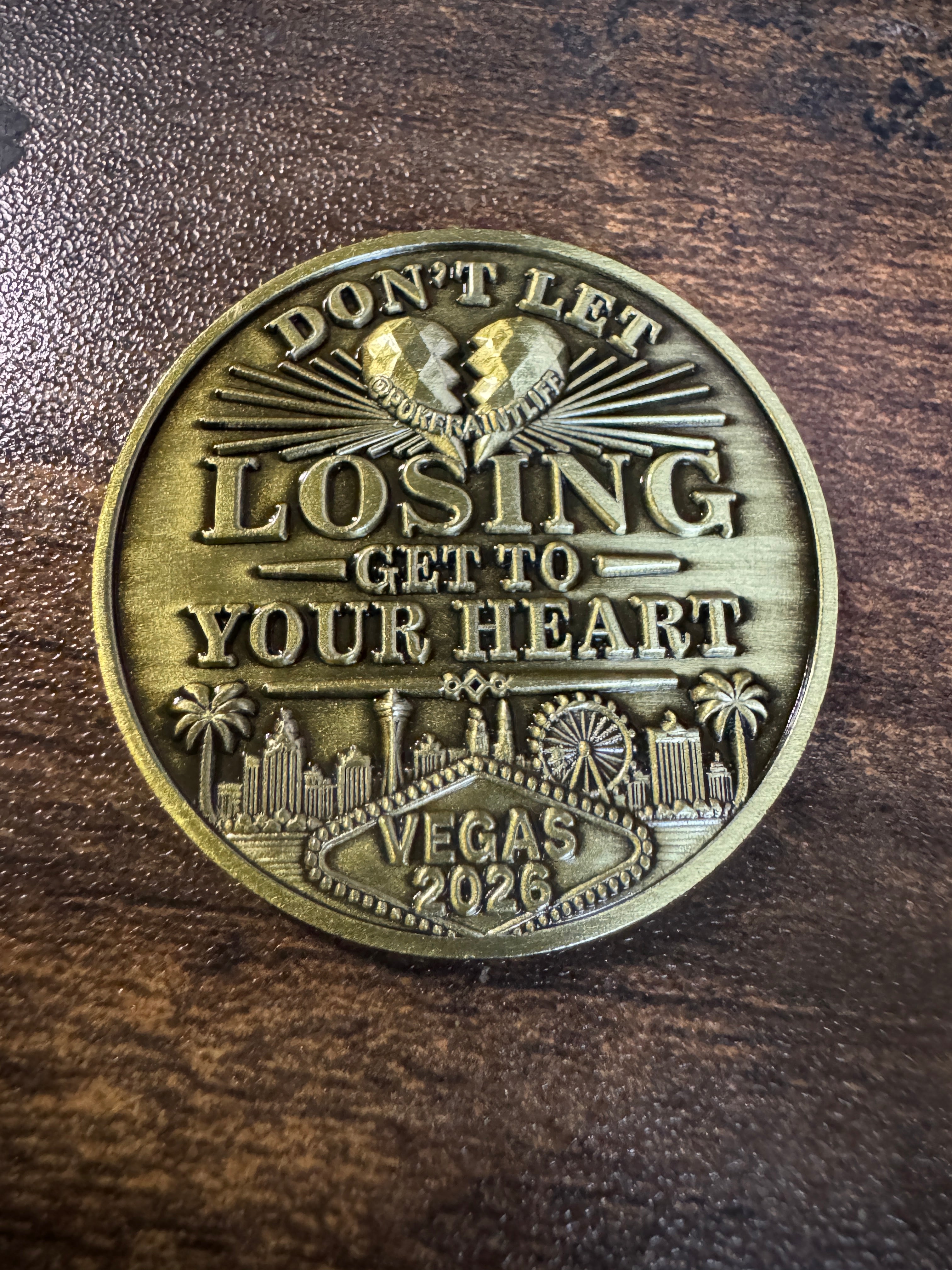 gold card protector coing that says dont let winning go to your head on one side and dont let losing go to your heart on the other side.