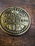 gold card protector coing that says dont let winning go to your head on one side and dont let losing go to your heart on the other side.
